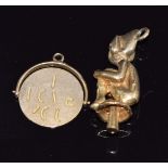 A 9ct gold charm in the form of a lucky pixie and a 9ct gold swivel pendant reading 'I Love You',