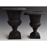 Two cast iron campana urns, height of taller 26cm