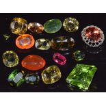 A collection of loose peridot, tourmaline, diopside, etc