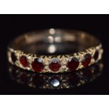 A 9ct gold half eternity ring set with garnets, 2.3g, size J
