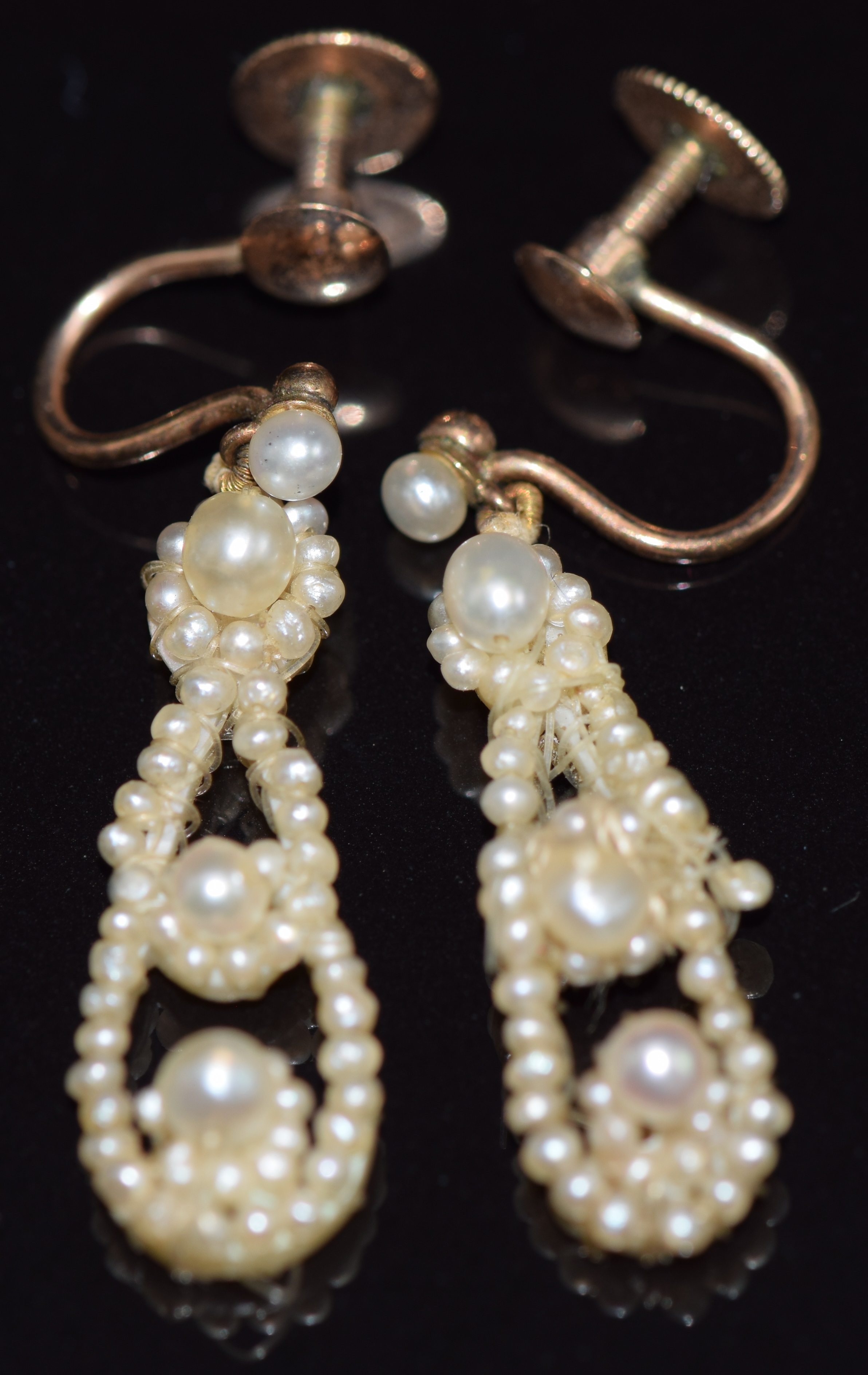 A pair of Victorian earrings set with pearls