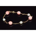 A 9ct gold bracelet set with alternating coral and pearls, 8g