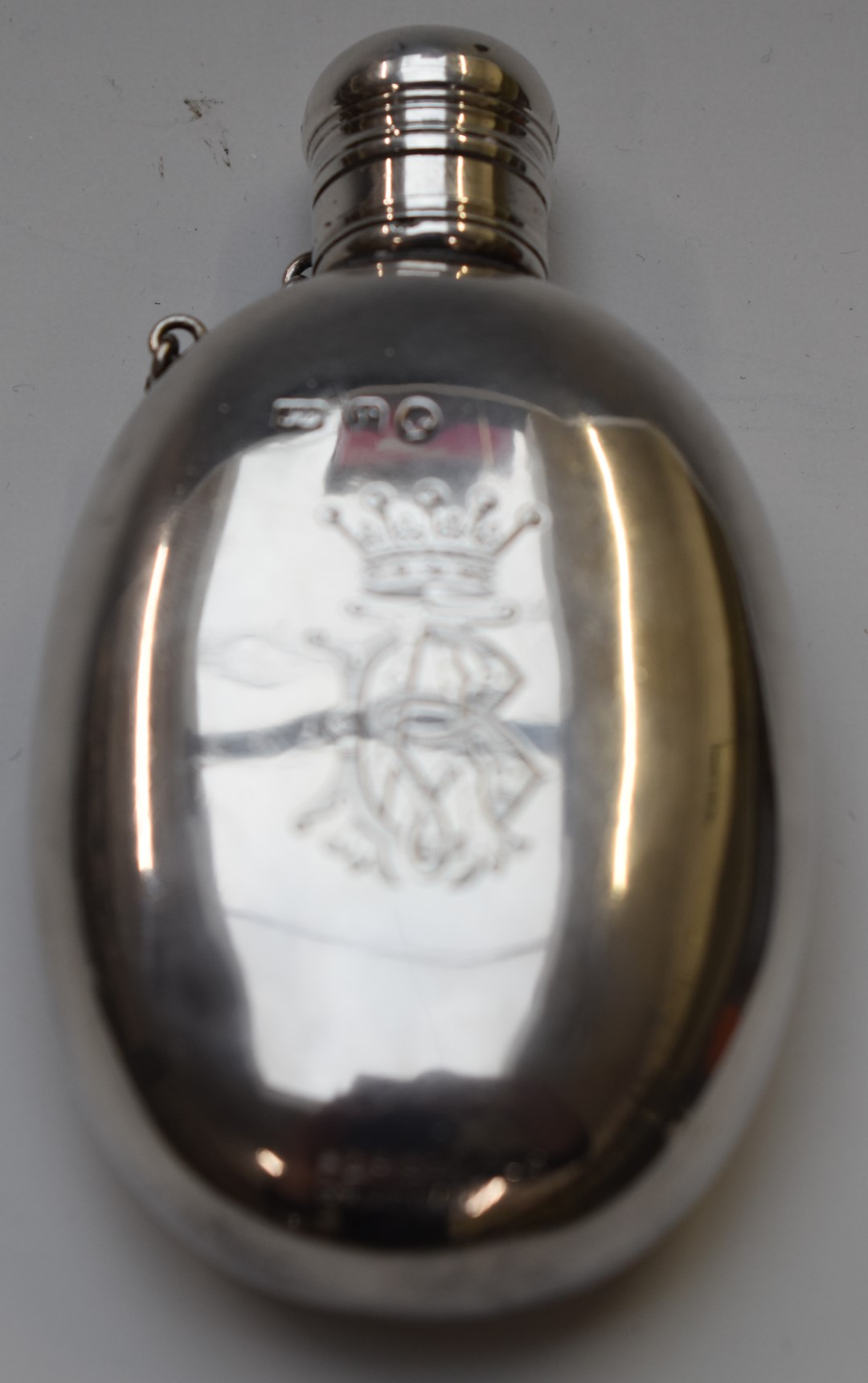 Victorian hallmarked silver oval hip or spirit flask with screw on lid retained by a chain, the body