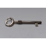 Modern novelty hallmarked silver key ring formed as a spring loaded key, London Ari D Norman, length