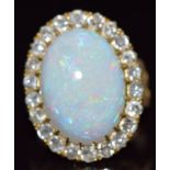 Victorian 18ct gold ring set with an oval opal cabochon of approximately 7cts surrounded by old