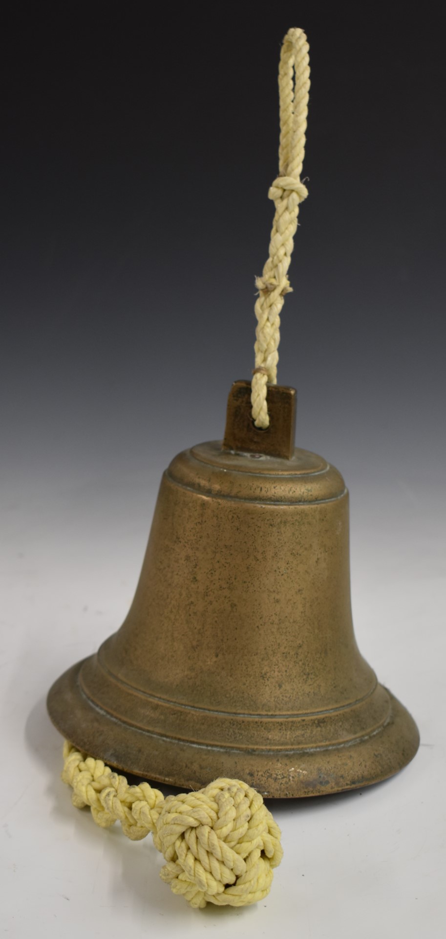Brass hand bell, hanging bell and a cast iron door porter with bird decoration and impressed 'Cannon - Image 4 of 4