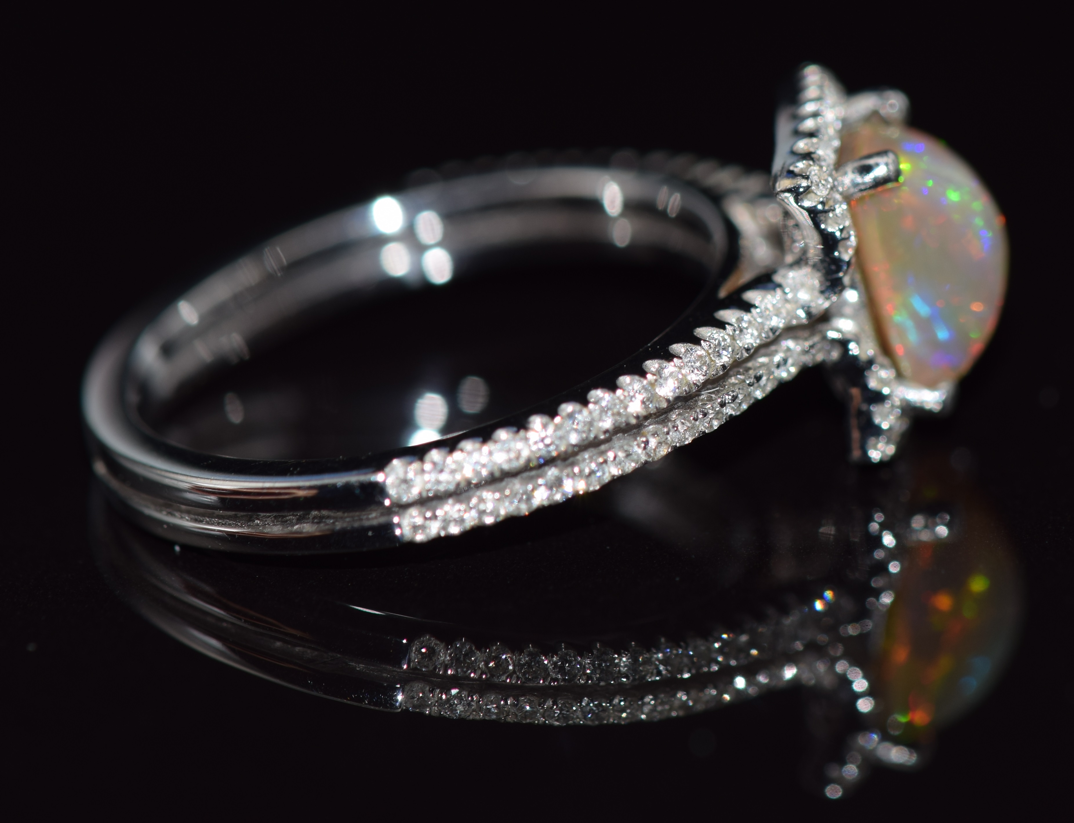 An 18ct white gold ring set with an Australian opal surrounded by diamonds and with further diamonds - Image 2 of 2