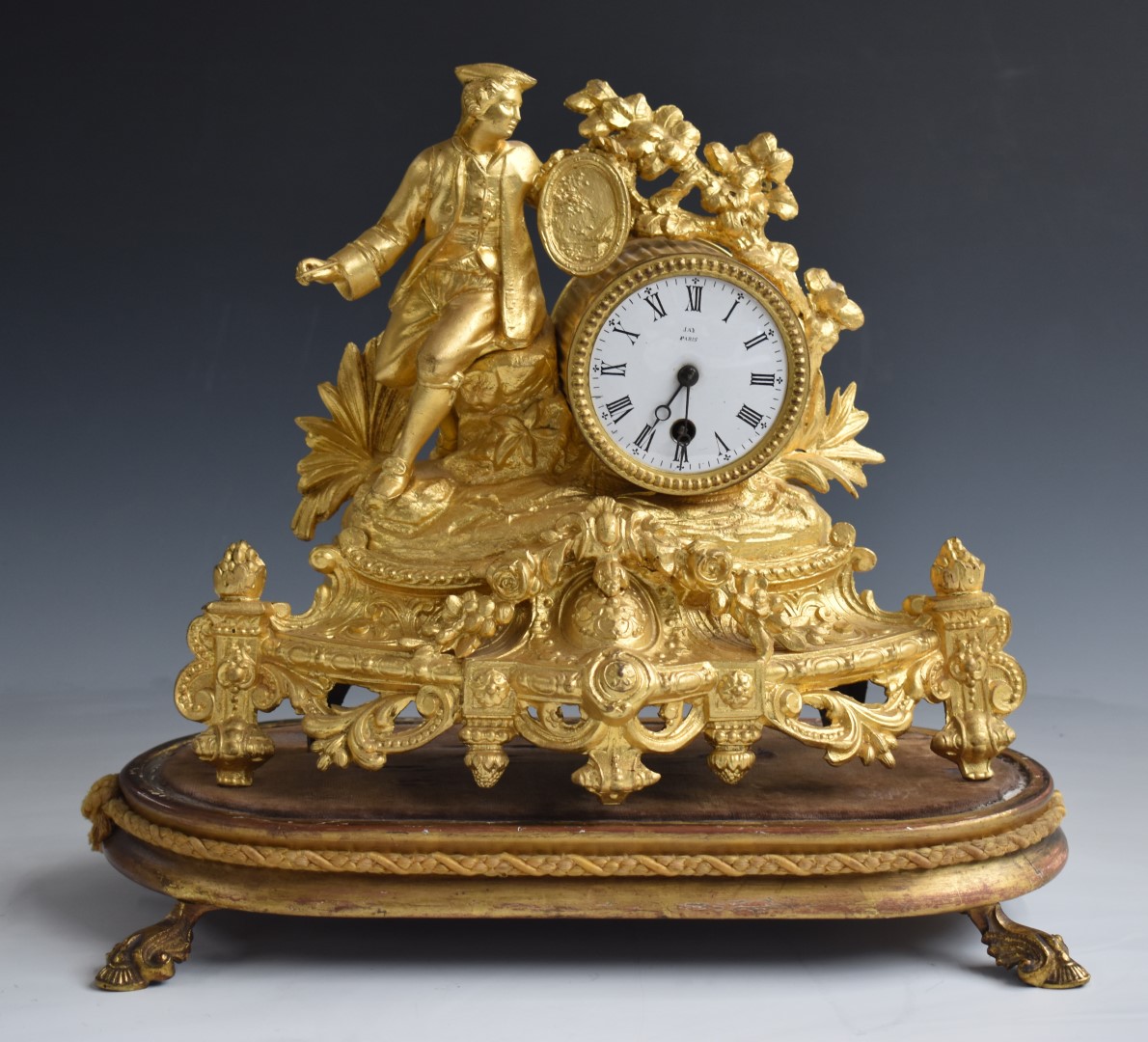 19thC French figural mantel clock featuring a seated artist, the 8cm enamelled dial marked Jay