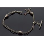 A white metal watch chain with acorn shaped beads and tassel charm, marked 800, 26cm