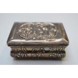 19thC Continental white metal hinged snuff box with relief decoration of figures and hunting dogs,