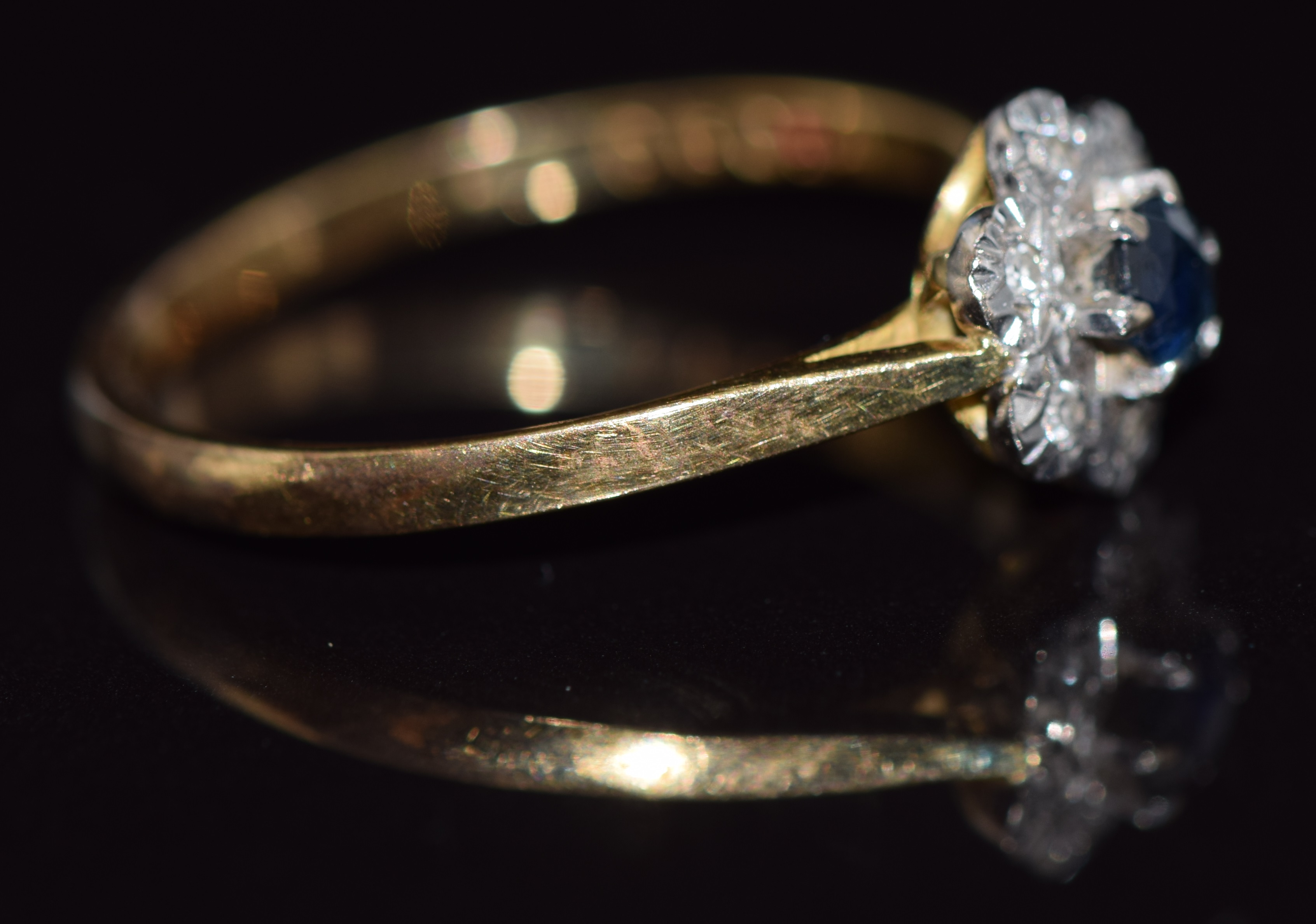 An 18ct gold ring set with a sapphire surrounded by diamonds, 2.3g, size O - Image 2 of 2