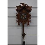 Mid to late 20thC carved wood German cuckoo clock in the Black Forest style, complete with two '