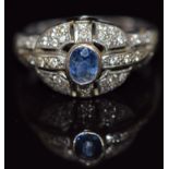An 18ct white gold ring set with a sapphire and diamonds, 6.1g, size N