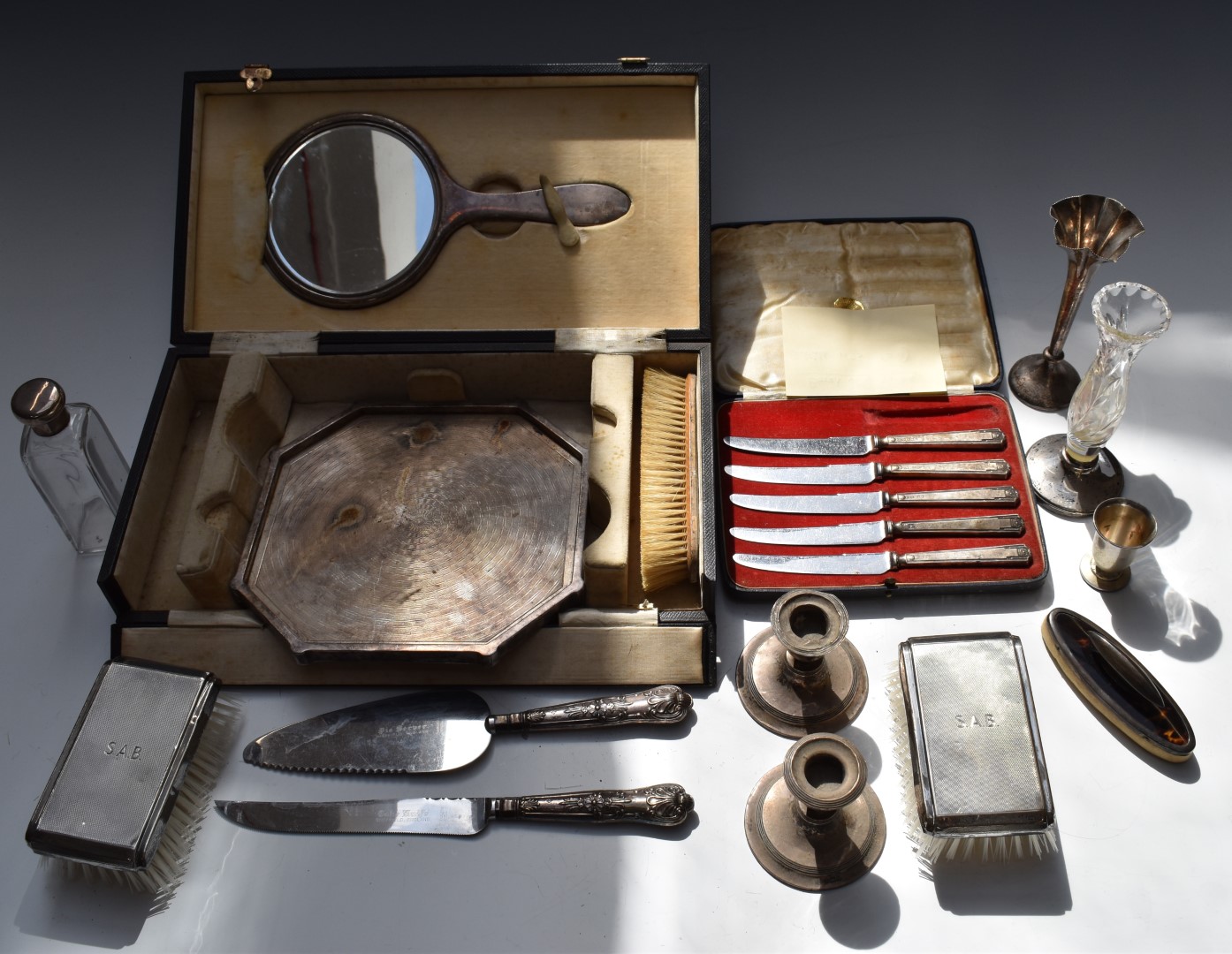 Hallmarked silver mounted items to include octagonal coaster or tray, brushes, hand mirror, silver