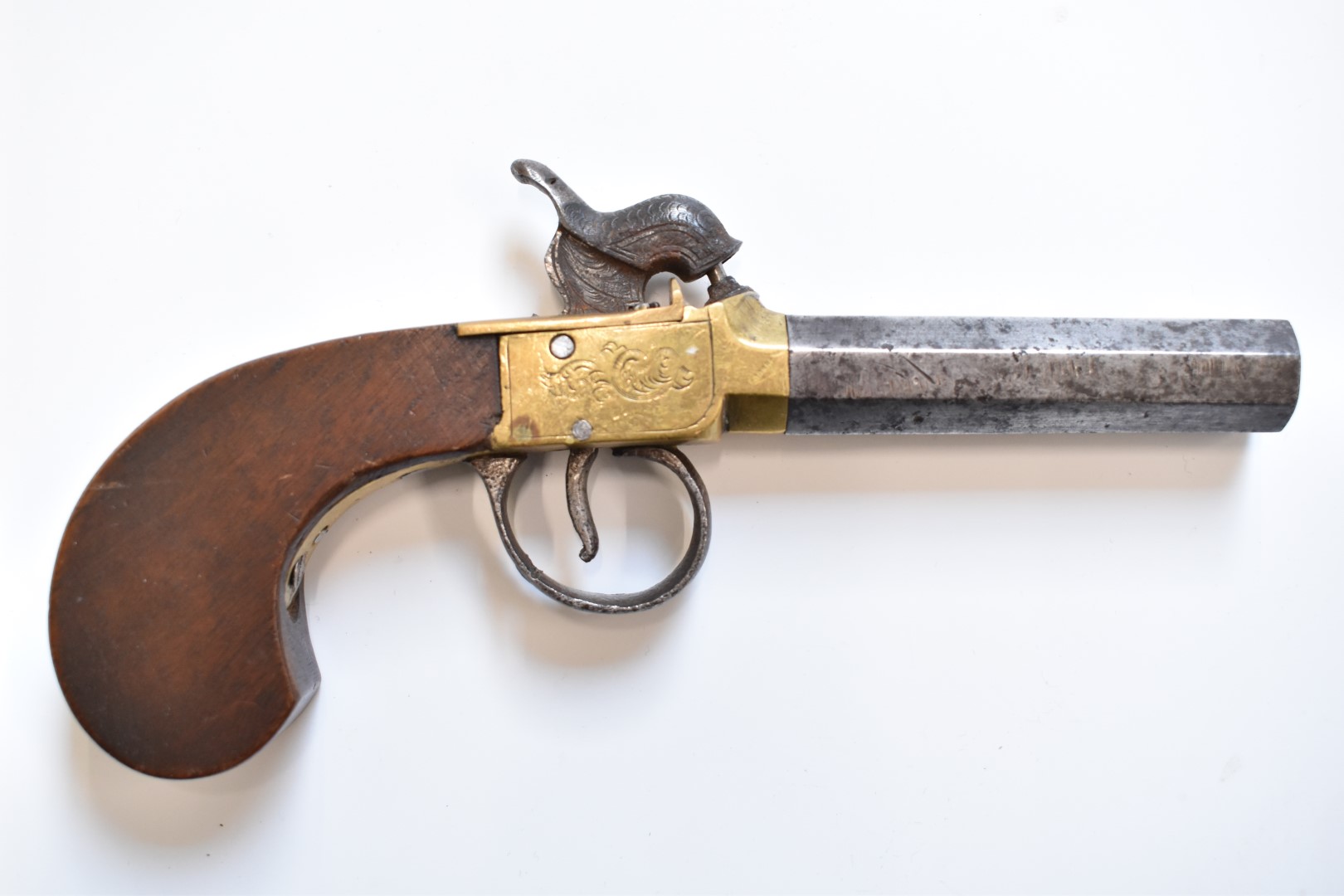 Unnamed single barrel percussion hammer action pocket pistol with engraved brass frame and top