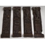 Four antique carved oak figural panels or caryatids with coats of arms below, 42x9.5cm