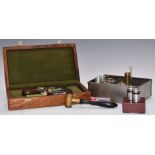A collection of shotgun tools and accessories including a cased set of three turned mahogany