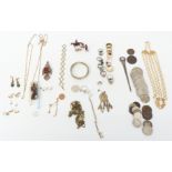 A collection of costume jewellery including Miracle pendant, silver rings, coins, necklaces, etc