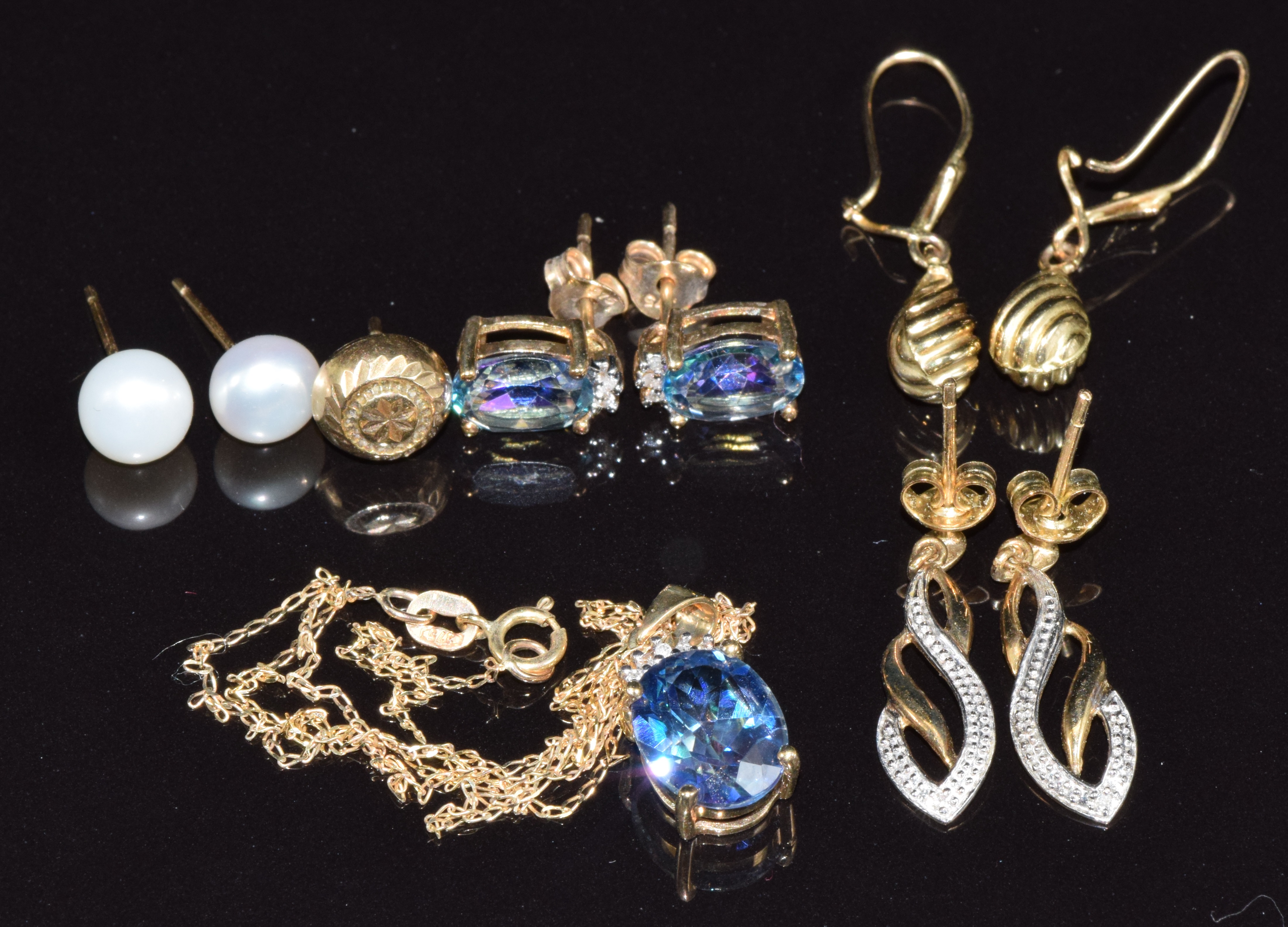 A 9ct gold necklace and earrings set with mystic topaz, three pairs of 9ct gold earrings and a