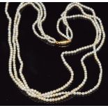 A three strand pearl necklace