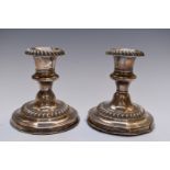 Edward VII pair of hallmarked silver candlesticks with gadrooned decoration, Birmingham 1906,