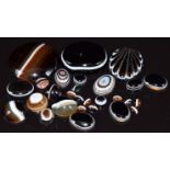 A collection of banded agate cabochons and a carved banded agate cabochon in the form of a shell