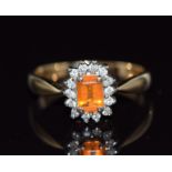 A 9ct gold ring set with an emerald cut fire opal surrounded by diamonds, 3g, size N