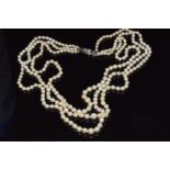 A three strand cultured pearl necklace with silver clasp