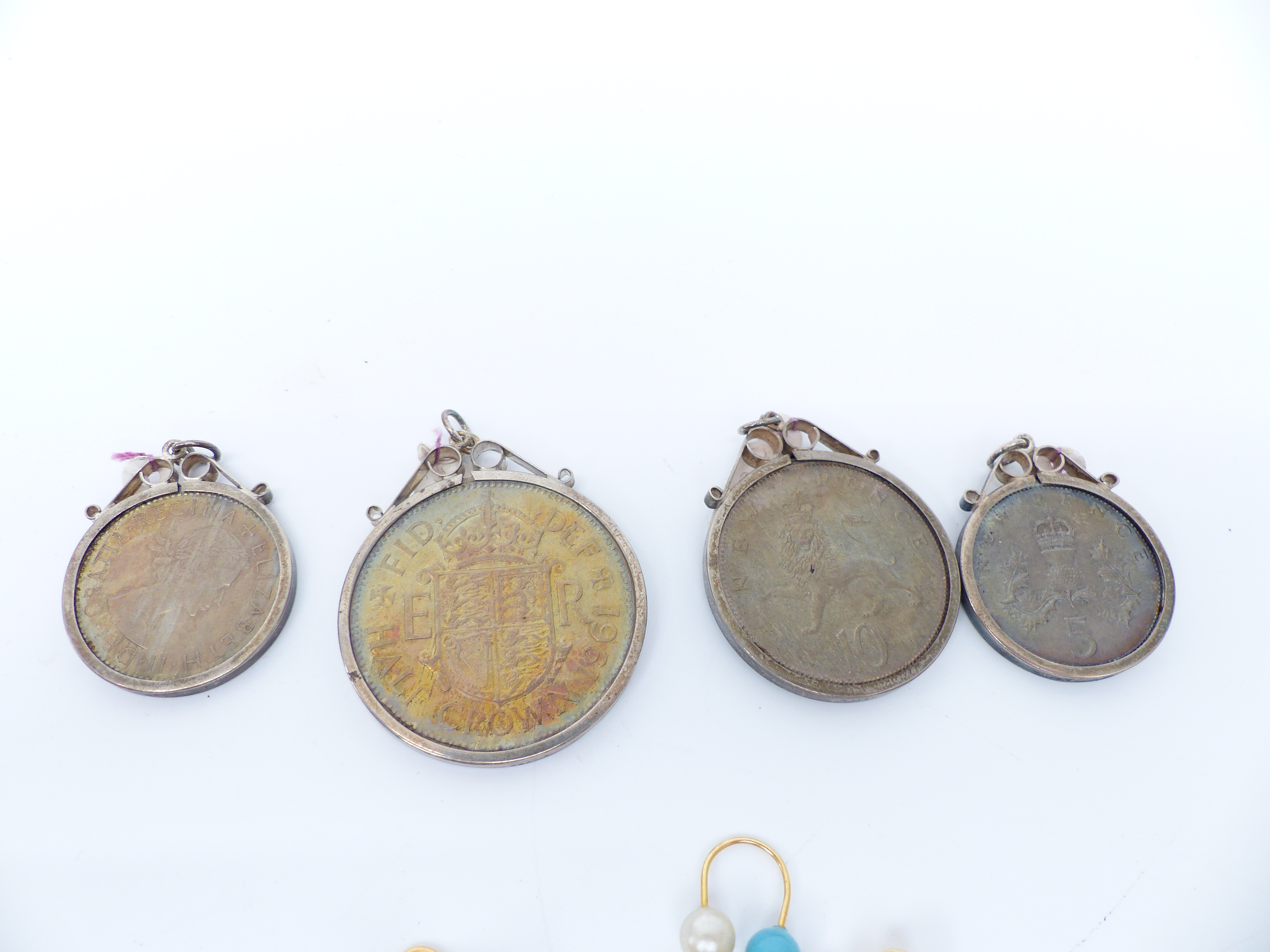 Four silver charms, a collection of floral links, four silver mounted coins, religious pendant, - Image 3 of 5