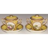 A pair of 18th/19thC twin handled porcelain covered chocolate cups and saucers decorated with a