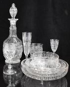 A large suite of cut drinking glasses and dessert bowls with hand etched Greek key design in the