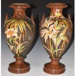 A pair of Watcombe South Devon pedestal twin handled vases decorated with birds and flowers, H34cm