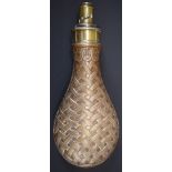 G & JW Hawksley copper and brass powder flask with basket weave decoration, 20.5cm long.