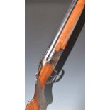 Miroku 12 bore over and under shotgun with border engraved lock, chequered semi-pistol grip and