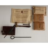 Desk top pen holder with a swivel gun adornment, shot measuring tool, three first field dressings