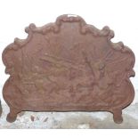 Antique cast iron fireback with relief decoration of mounted riders in a battle scene, Fladbury