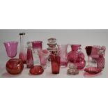 A collection of cranberry glass including enamelled, cut glass, and silver mounted examples, largest