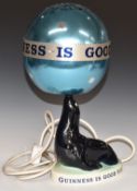 Carltonware 'Guinness is Good For You' figural sea lion convector lamp with revolving ball/shade,