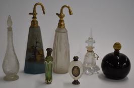 Seven glass scent or perfume bottles including one Daum style, two with white metal mounts, a