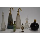 Seven glass scent or perfume bottles including one Daum style, two with white metal mounts, a