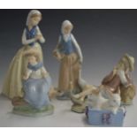 Lladro figure of a reclining boy and four Nao figures, tallest 27cm