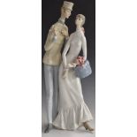 Lladro figure of a girl with a hatbox talking to a bellboy, H44cm