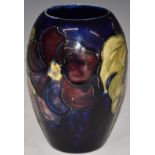 Moorcroft vase decorated in the Clematis pattern on blue ground, H13cm