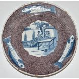 English Delft plate, London c1750, decorated with a chinoiserie garden scene of two figures at a