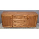 Retro / mid century Ercol light elm Windsor sideboard comprising of three central drawers with
