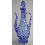 Glass ewer with blue and white cotton twist decoration, signed to base, 28cm tall.