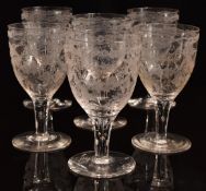 A set of six 19thC clear glass wine glasses with engraved decoration of birds, flowers and