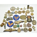 Small collection of military and Civil Defence metal and cloth badges and insignia including ARP