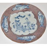 English Delft plate, London c1750, decorated with a chinoiserie garden scene within a border of four