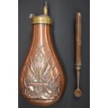 Copper and brass powder flask with embossed decoration of a cannon and flags together with a